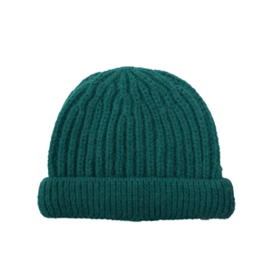 Detail of dark green ribbed knit beanie showing thick vertical texture and folded brim