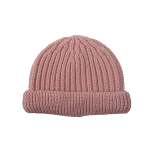 Detailed close-up of soft pink ribbed knit beanie showing thick texture and elastic weave
