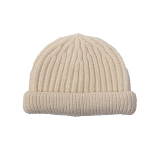 Detailed view of the soft ribbed texture and wide folded brim of the cream knit beanie