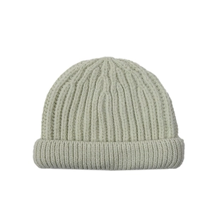 Close-up of sage green ribbed knit texture on a folded winter beanie for kids