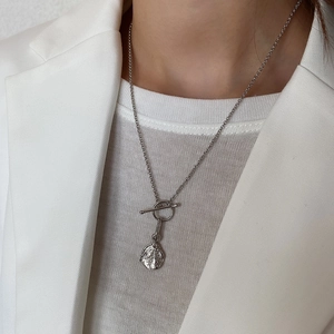 Detailed close-up of 925 sterling silver necklace with lava texture pendant and T-bar clasp