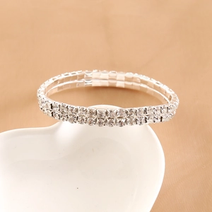 Elegant silver-colored double-row crystal stretch bracelet on white ceramic heart tray