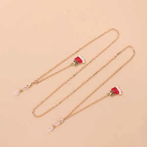 Detail of gold metal eyeglass chain with festive red and white enamel Christmas bells