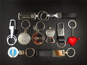 Collection of custom metal and leather keychains with laser engraving details