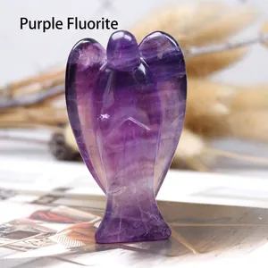 Macro shot of hand-carved purple fluorite crystal angel with natural mineral textures