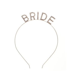 Detailed view of the sparkling BRIDE crystal rhinestones on a gold bridal headband accessory