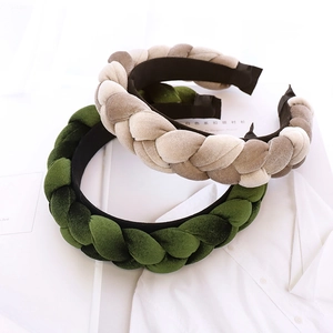 Handmade braided velvet headbands in green and beige shown on a minimalist background