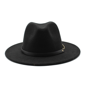 Detailed shot of wide brim wool fedora with black leather band and gold chain accent