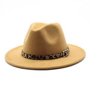 Detailed texture of camel fedora hat with leopard print band and gold metal buckle