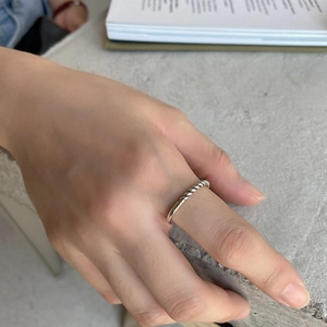 Minimalist 925 sterling silver twisted rope ring shown on model's index finger