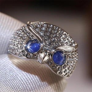 Silver owl ring with large blue cat-eye stones and pavé cubic zirconia details