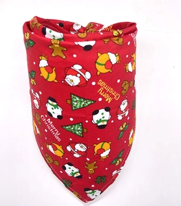 Close-up of red cotton Christmas dog bandana featuring festive prints and soft fabric texture