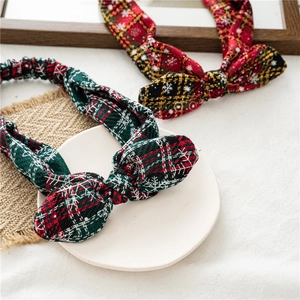 Detail of Christmas plaid knot headbands featuring snowflake patterns on soft fabric