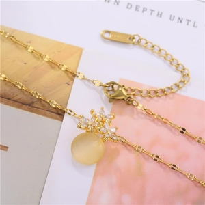 Golden titanium steel necklace featuring a cat-eye stone flower pendant with zircon inlays