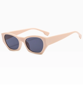 Close-up of geometric cat-eye sunglasses with beige frames and dark polarized lenses