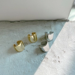 Set of four minimalist silver and gold ear cuffs with a smooth polished metallic finish