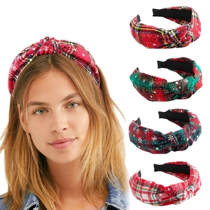 Detailed view of checkered Christmas headbands with snowflake patterns in a set of four