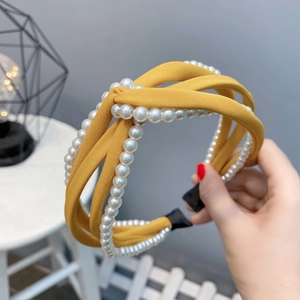 Detail of ginger yellow chiffon knotted headband with double rows of white pearls