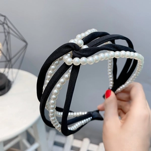 Detail of a black twisted chiffon headband featuring elegant layered faux pearl strands