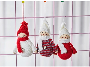 Three handcrafted felt snowmen with knitted hats and wooden stars for Christmas tree decor