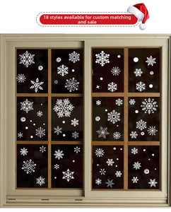 Detail view of 18 assorted white snowflake static window stickers for Christmas decor