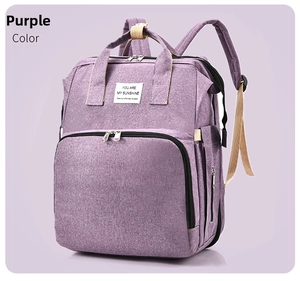Front detail of lavender purple foldable diaper backpack with beige handles and woven label