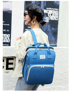 Blue multifunctional baby diaper backpack with 'You Are My Sunshine' label shown on a model