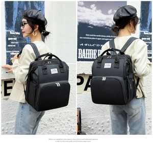 Detailed split view of black multipurpose diaper backpack with ergonomic shoulder straps
