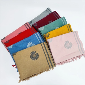 Folded colorful cashmere scarves with daisy pattern and fringe in eight elegant shades