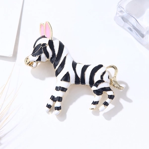 Handcrafted vintage zebra brooch with black and white enamel stripes and gold trim