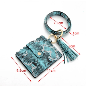 Detail view of blue snake skin pattern PU leather card holder with tassel and bangle keyring