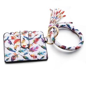 Detail of PU leather card holder wristlet with feather print and gold metal clasp