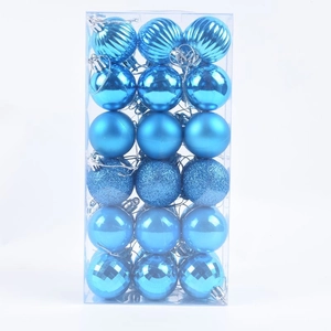 Detail of 36-piece blue Christmas balls with diverse textures in transparent box