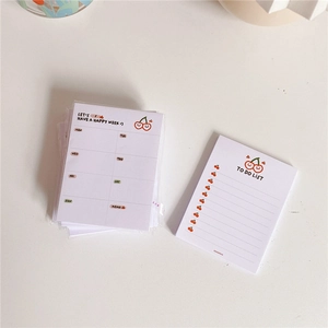 Top view of cherry pattern weekly planner and to-do list notepad stationery set