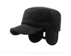 Detail view of the warm winter flat cap featuring a metallic R logo and ear flaps