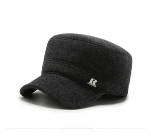 Detail of dark grey wool flat top military cap with metal logo for men's winter warmth
