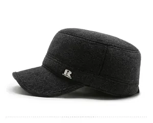 Detail of dark grey wool cadet cap showing herringbone texture and metal logo