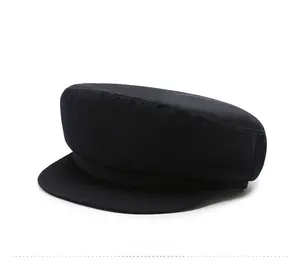 Detailed side profile of a black cotton flat top navy style hat with stiff brim and twill fabric