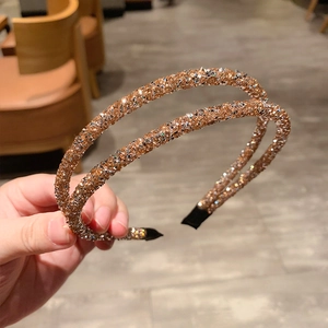 Detail of double-row champagne crystal headband with black fabric-covered ends