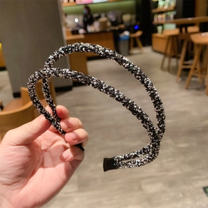 Detail of a double-layered black and silver headband featuring delicate sparkling rhinestones