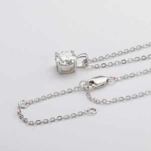 Macro shot of 925 silver 4-prong moissanite pendant with adjustable lobster clasp chain