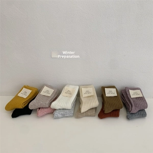 Close-up of ribbed knit wool socks in diverse Morandi colors for winter warmth