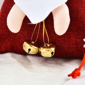Christmas gift bag in red linen featuring golden bells and Santa Claus 3D doll elements