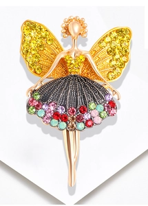 Macro detail of ballerina brooch with colorful rhinestones on a gold-plated base
