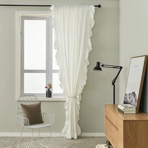 Detailed view of a white cotton linen small window curtain with elegant ruffled edges