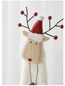Close-up of a Nordic Christmas reindeer decor with white plush body and wood details