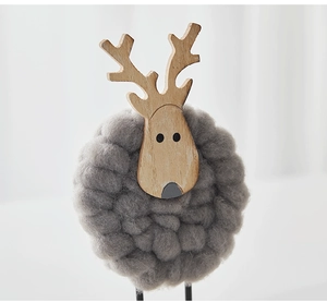 Detail of Nordic wooden reindeer decor with thick grey wool felt and natural wood grain