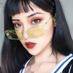 Modern square candy-colored sunglasses in transparent yellow frame worn by a model