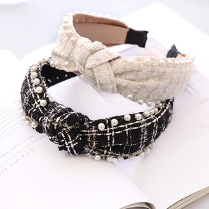 Detail of tweed knotted headbands with pearl accents in cream and plaid patterns