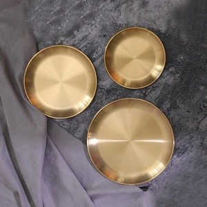 Set of three Nordic vintage gold metal storage trays with elegant brushed finish texture